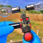 Handheld DIY hazard light LED circuit project with 12V indicator bulbs and relay close up shot.
